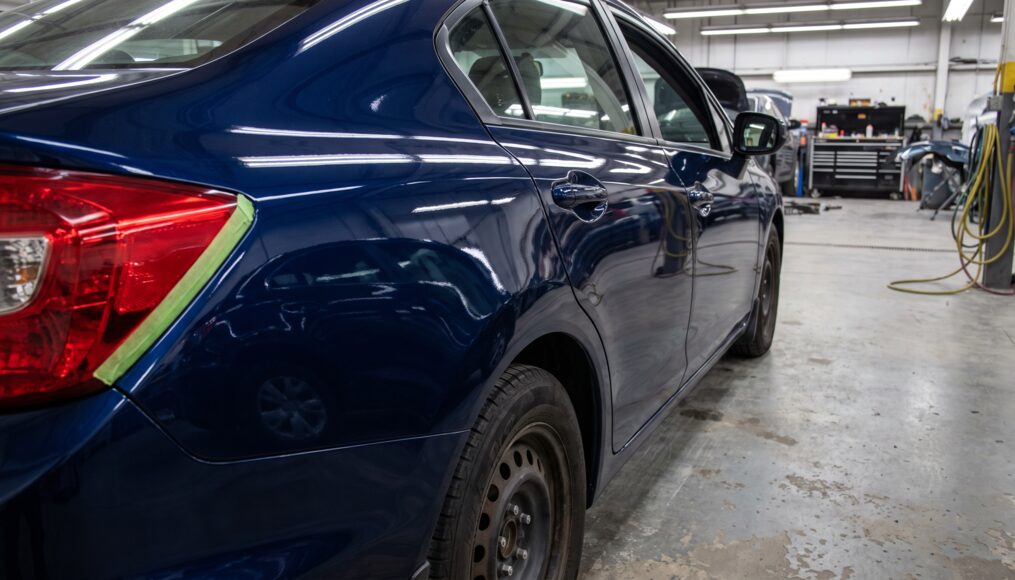 Repaired rear quarter panel with fresh refinish work in the Ridgeline shop