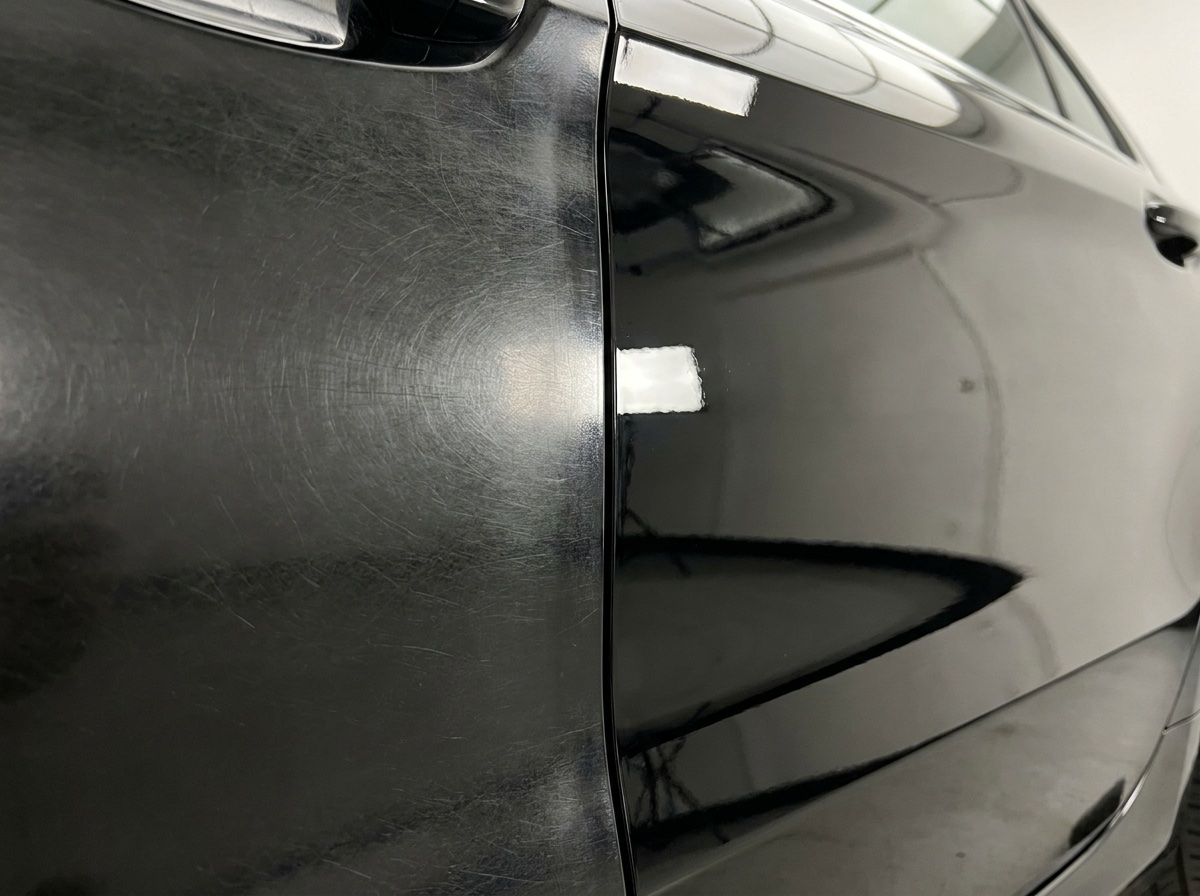 Door panel split: swirl-marked haze on the left, mirror gloss after machine polishing on the right